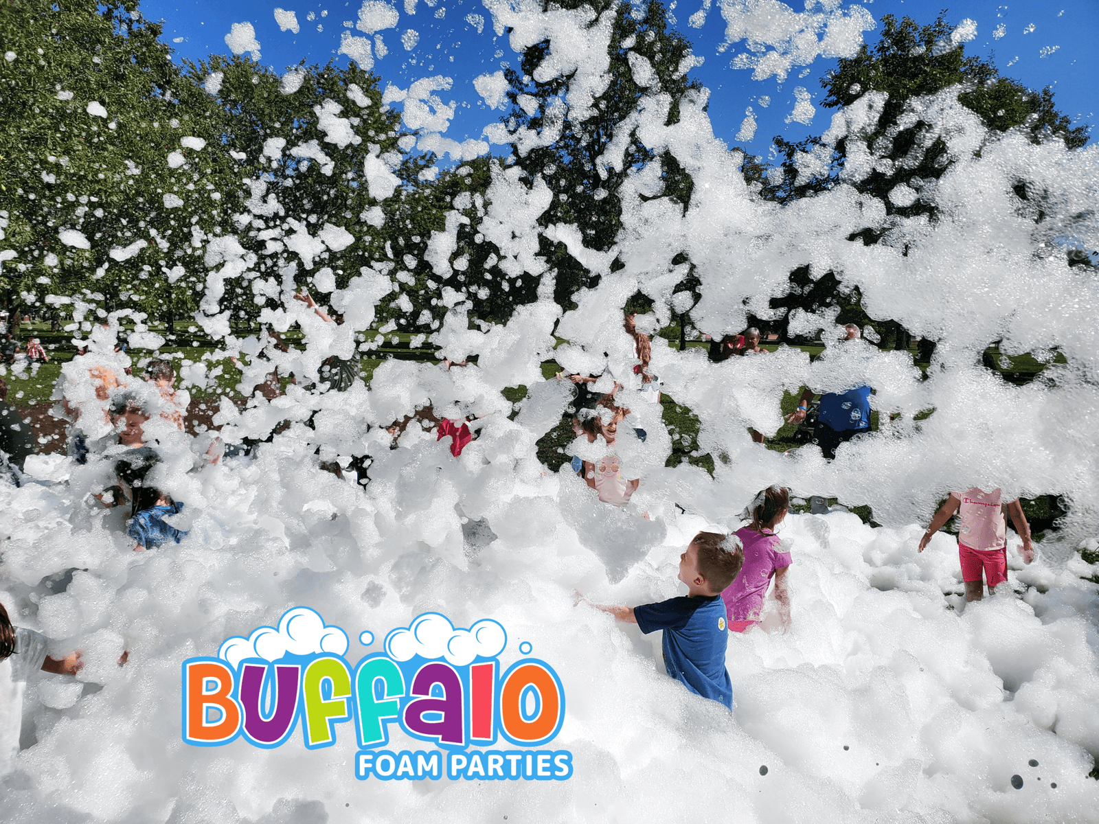 Children playing in a giant foam party at an outdoor event in Amherst NY